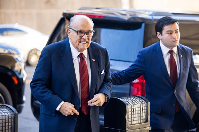 <p>Rudy Giuliani arrives for the first day of a defamation trial in federal court in Washington DC on 11 December</p>