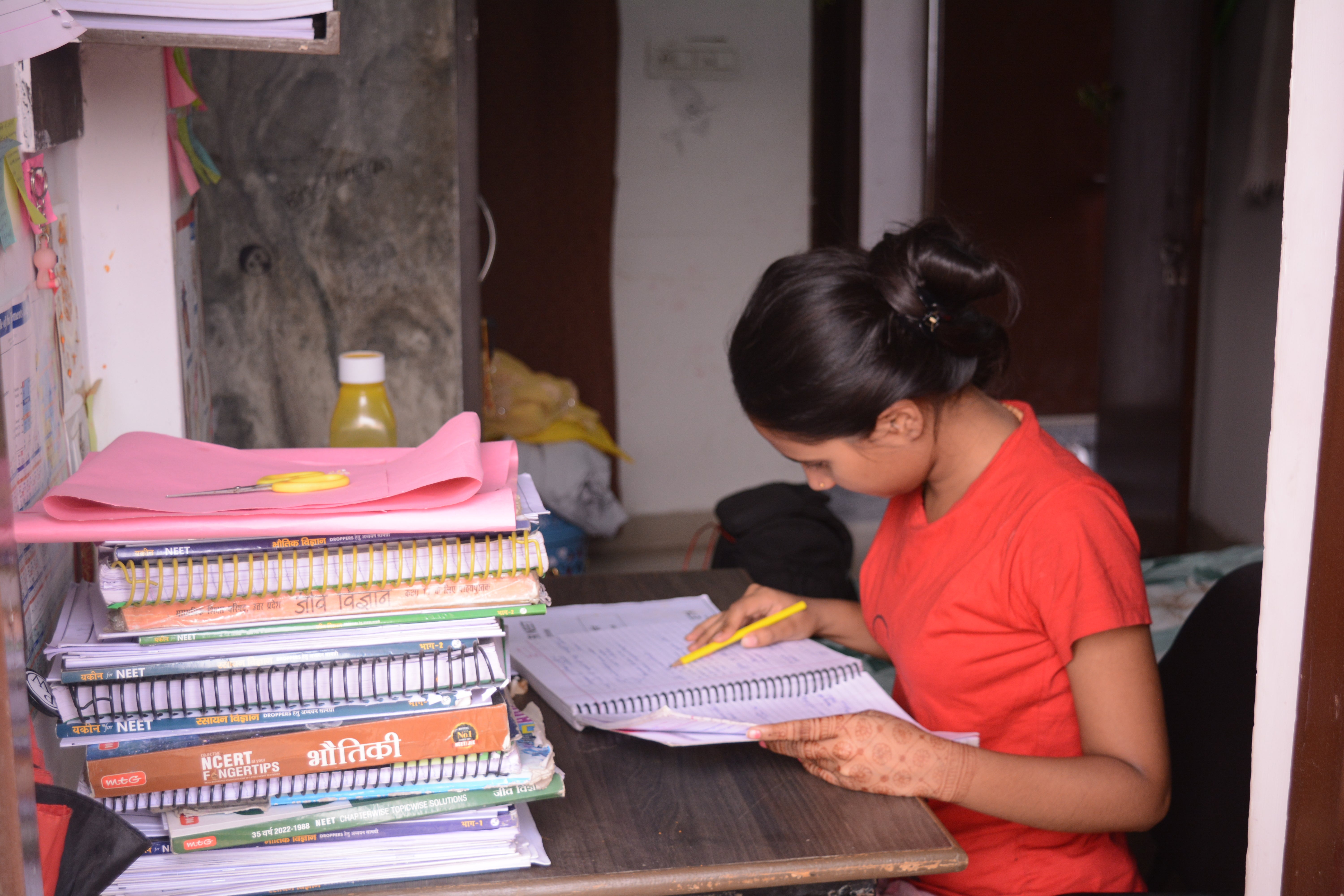 A student preparing study material provided by her coaching centre to help crack entrance exams