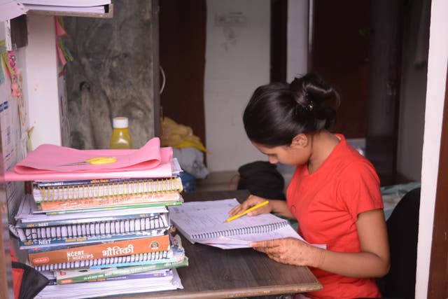 <p>A student preparing study material provided by her coaching centre to help crack entrance exams</p>