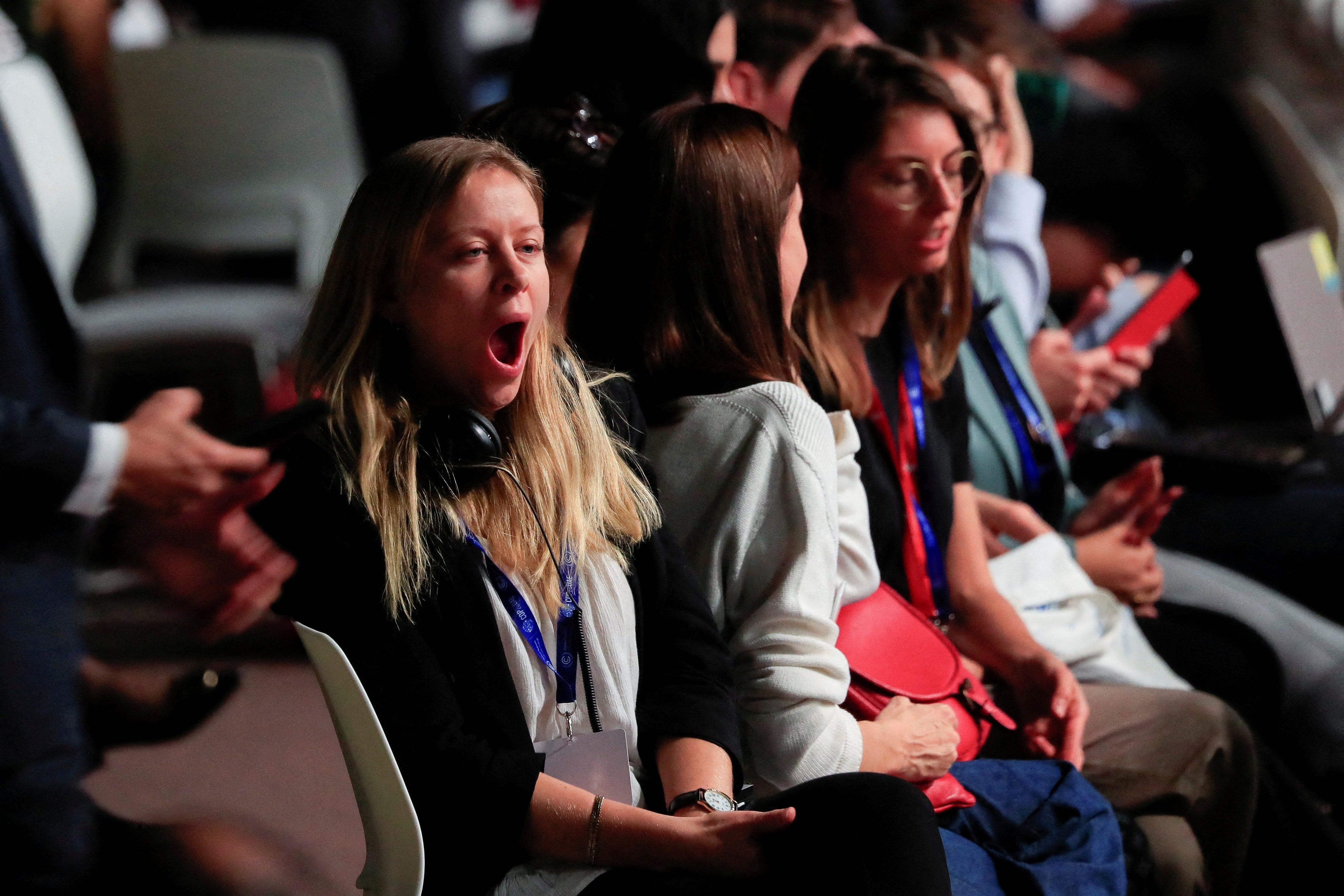 A Cop28 delegate yawns as negotiations continued into the early hours of Tuesday