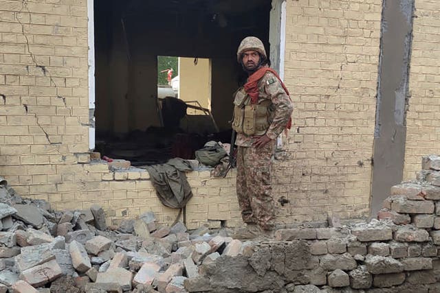 <p>An army soldier examines damages on the site of a bombing at a police station on the outskirts of Dera Ismail Khan, Pakistan, 12 Dec 2023</p>