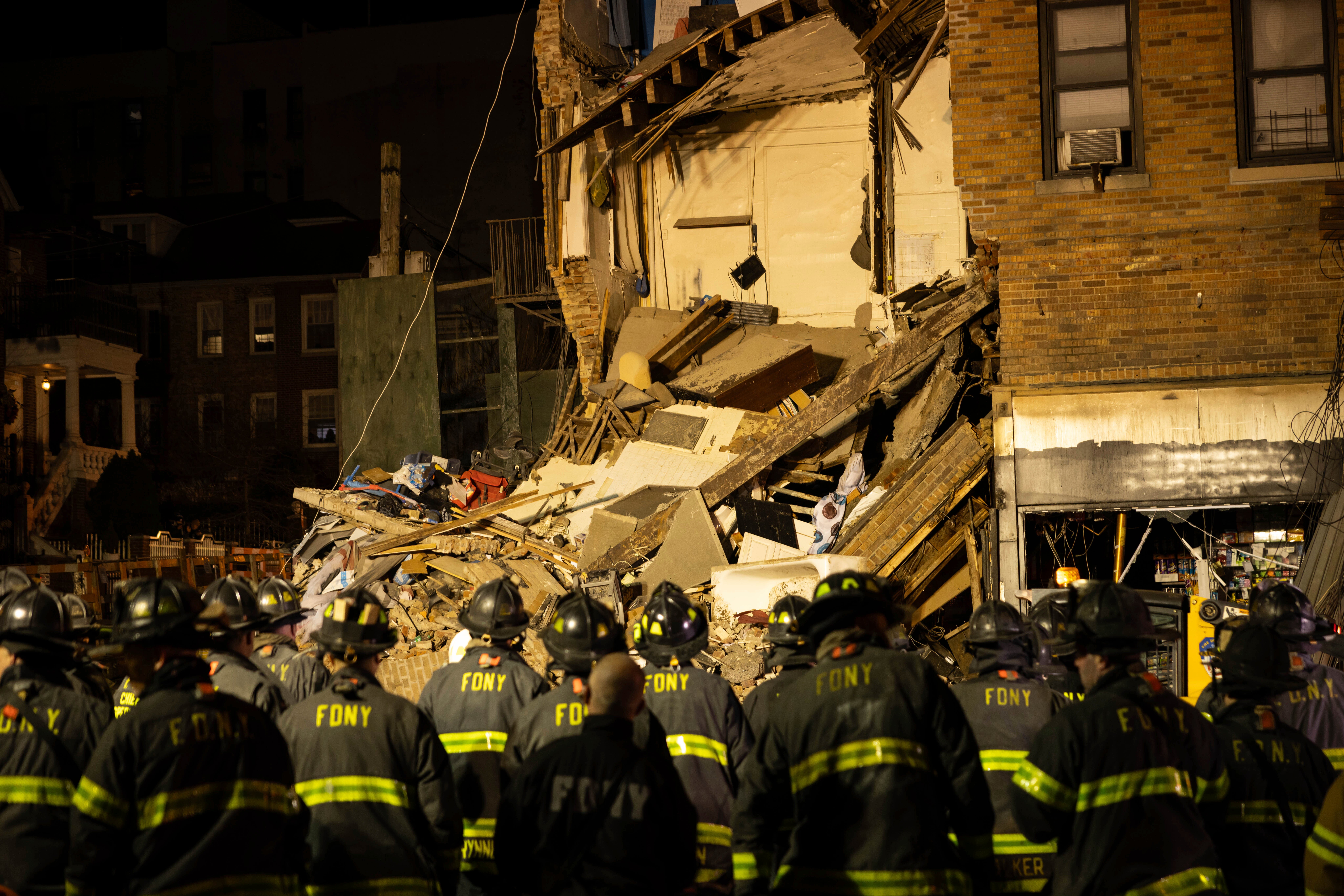 Firefighters assembling at the scene of a collapsed building in the Bronx