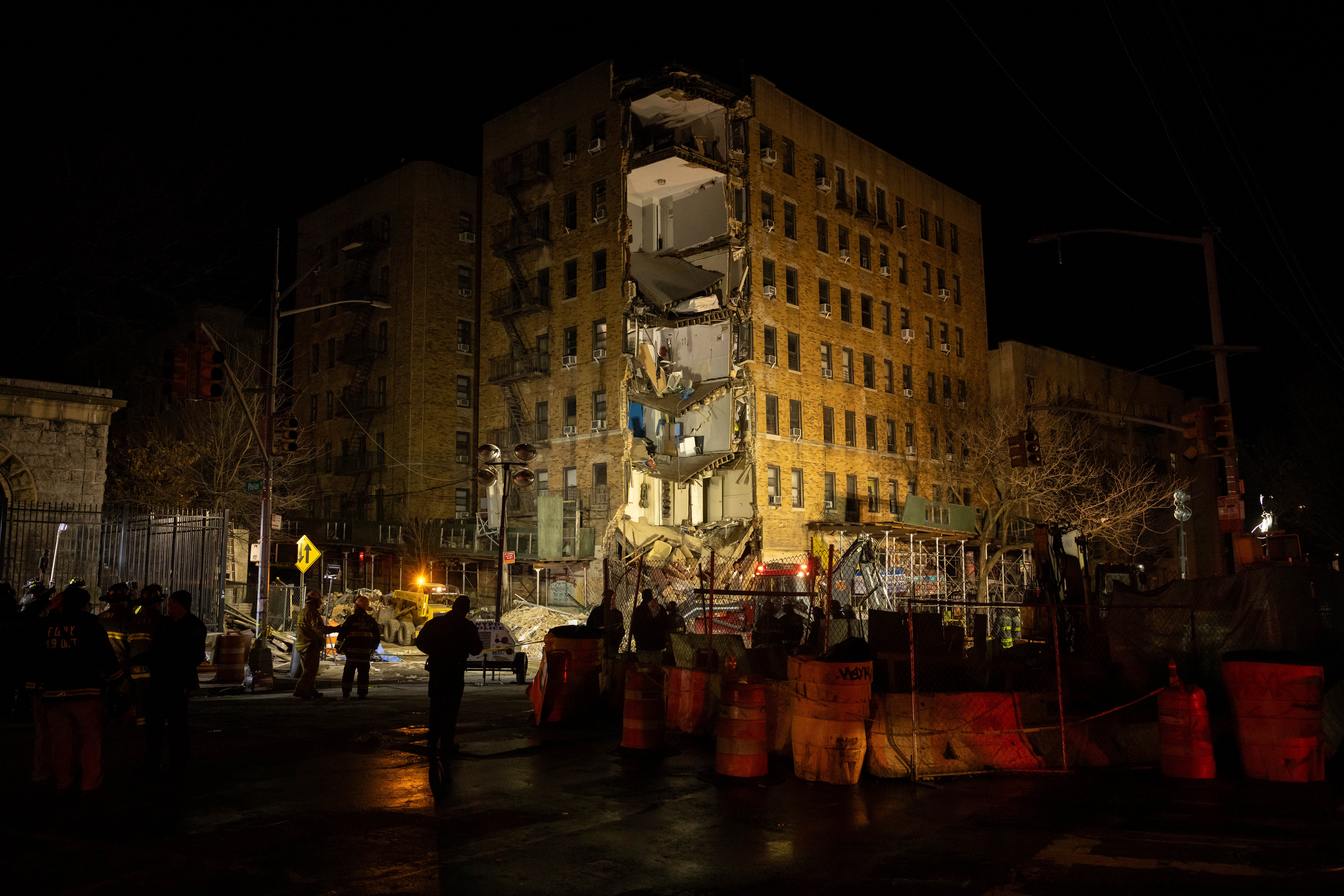 First responders stand at the scene of a collapsed building in the Bronx