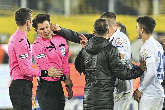 <p>Turkish club president Faruk Koca punches referee Halil Umut Meler on Monday </p>