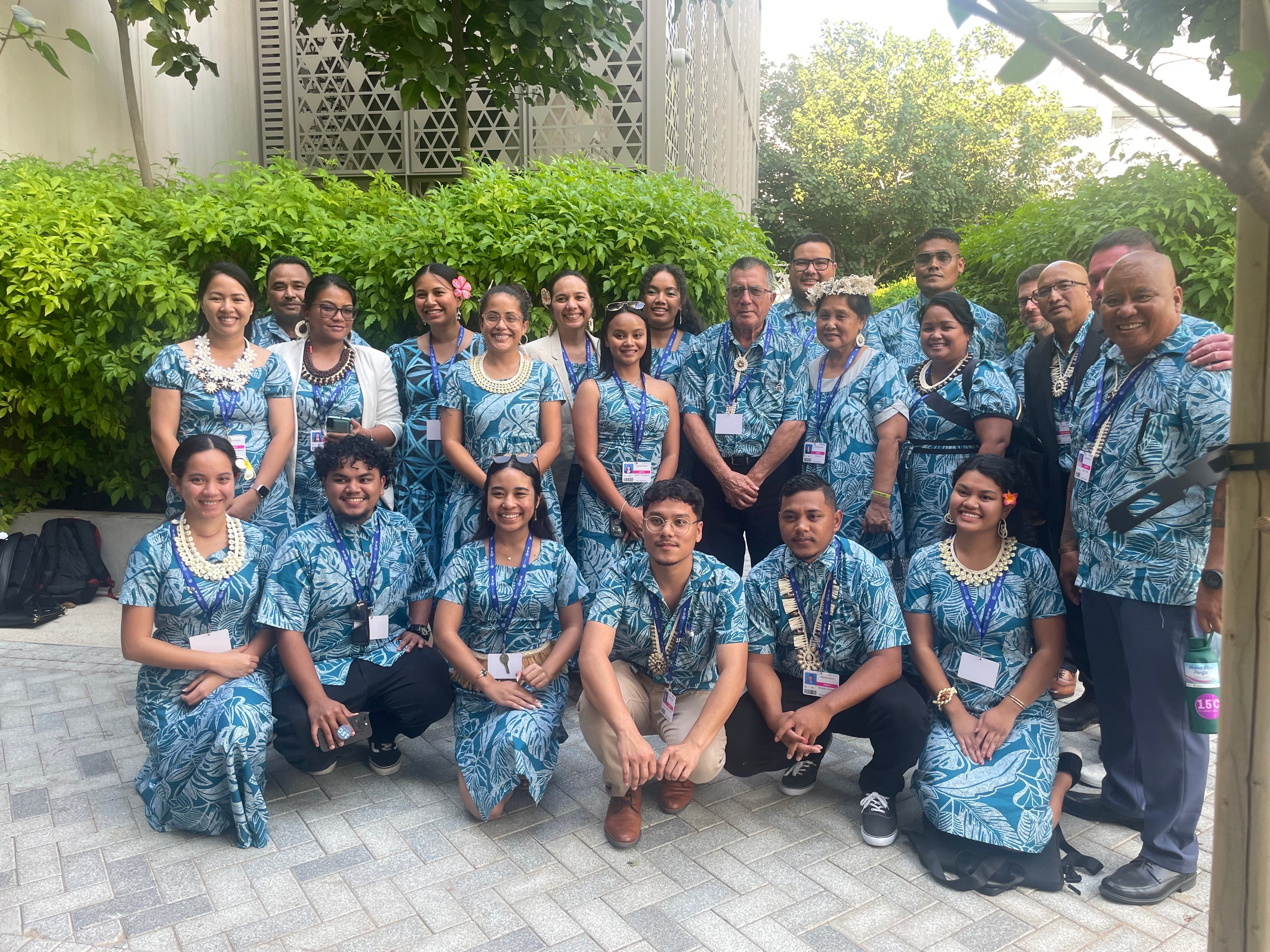 Some of Marshall Islands delegation take a group picture in coordinating outfits after launching their National Adaptation Plan at Cop28