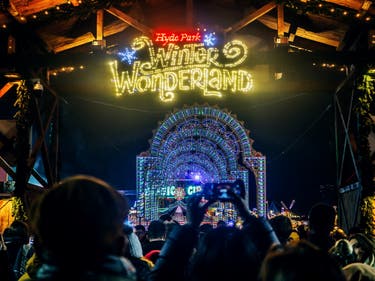 <p>People walking in the Christmas market of the Hyde Park's winter Wonderland in London</p>