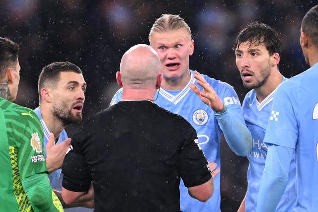 <p>Erling Haaland has words with referee Simon Hooper during the Premier League match between Manchester City and Tottenham Hotspur on 3 December</p>