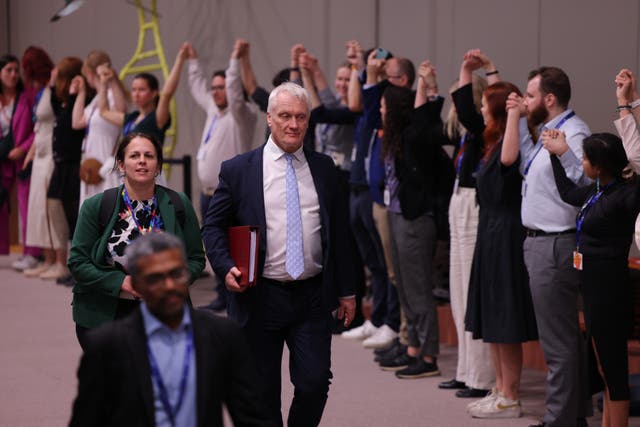 <p>The UK’s climate minister, Graham Stuart, centre, at Cop28 in Dubai</p>