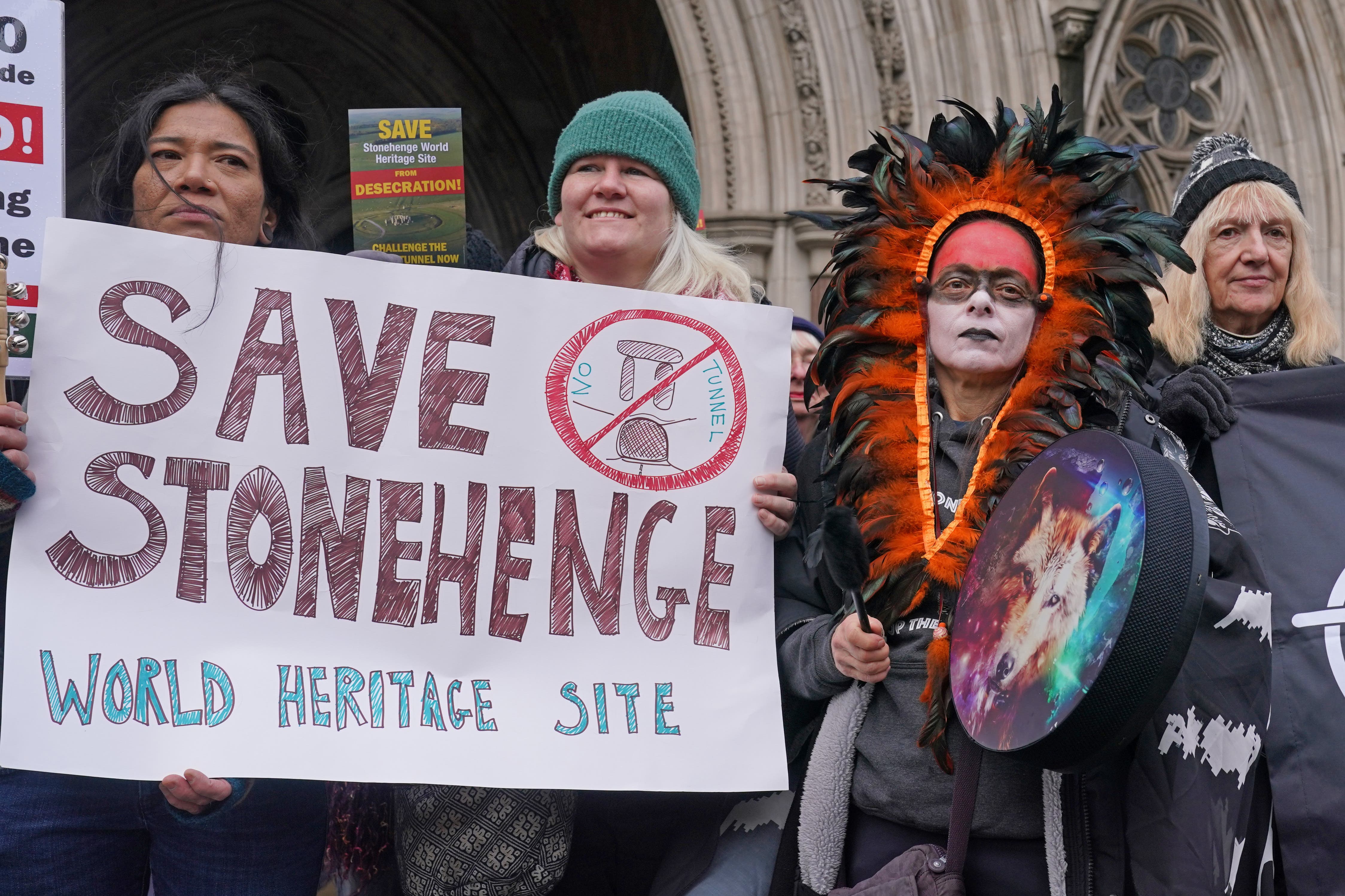 Campaigners outside the High Court in London amid a bid to block a controversial road project featuring a tunnel near Stonehenge (Lucy North/PA)