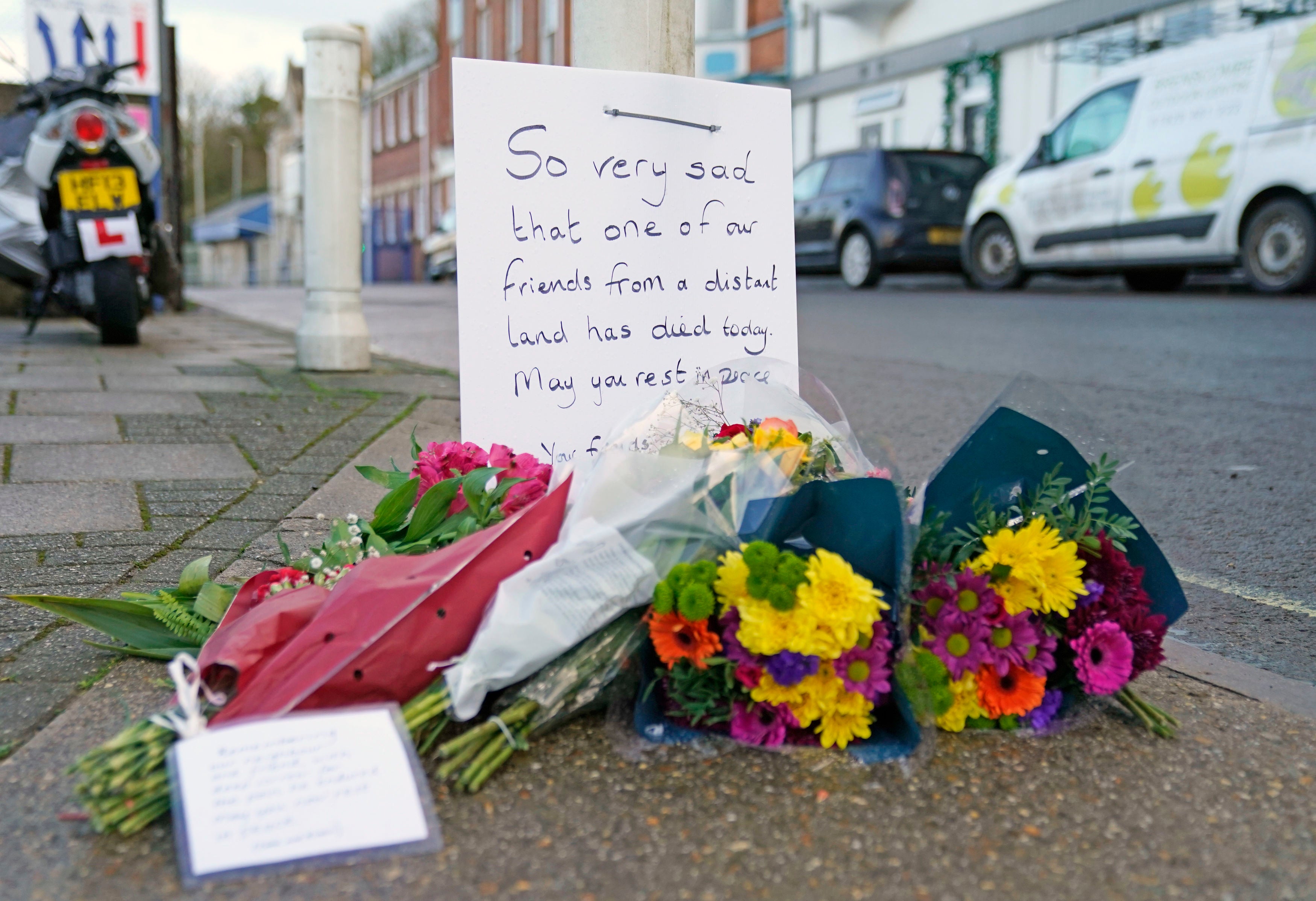 Flowers are left at the entrance at Portland Port in Dorset, following the death of an asylum seeker on board the Bibby Stockholm