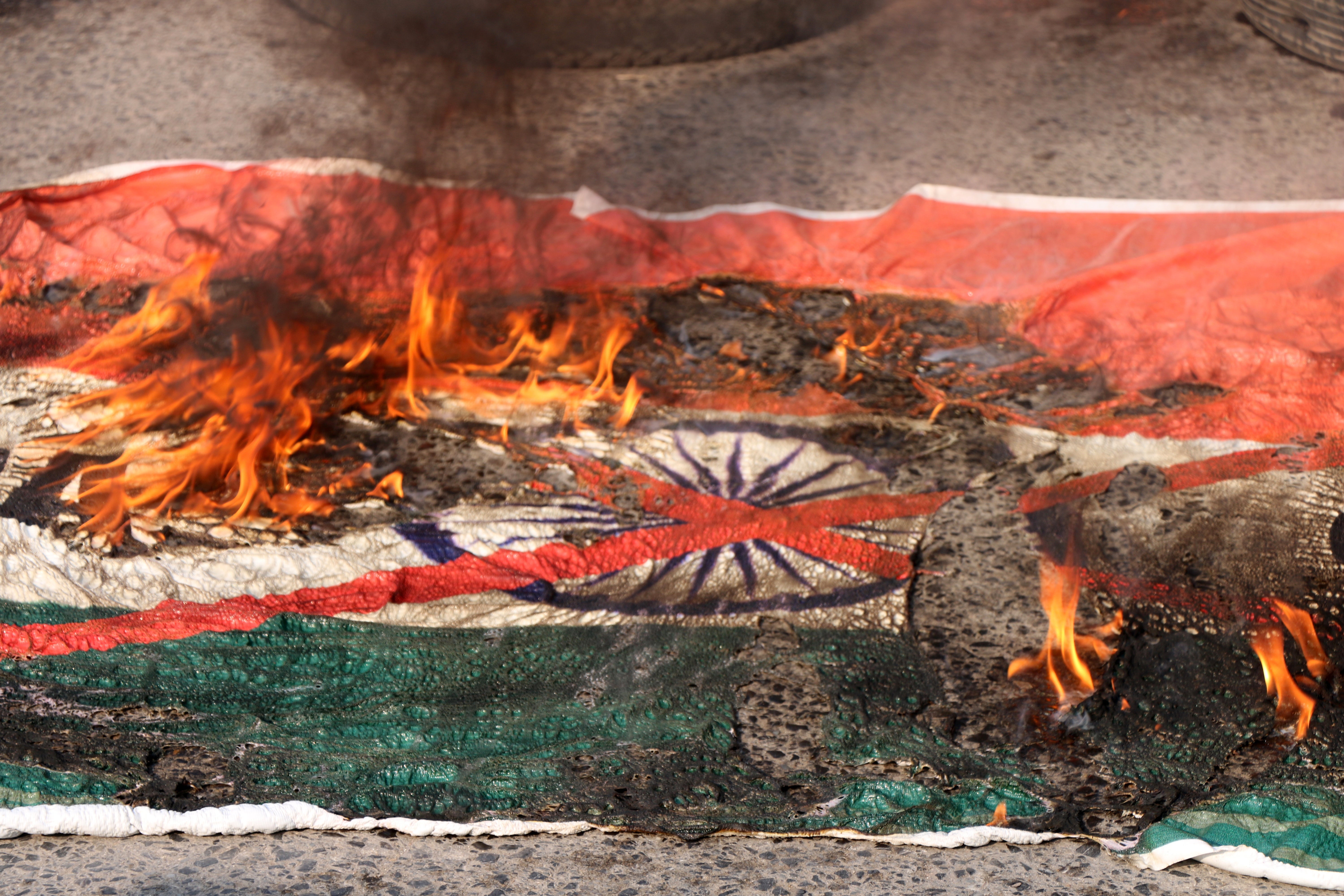 People burn an Indian flag as they protest against the Supreme Court decision on Indian Kashmir’s special status, in Muzaffarabad, Pakistan-administered Kashmir, in December 2023