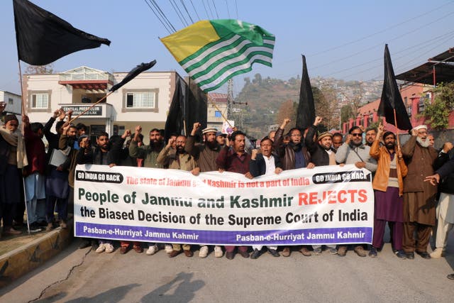 <p>People gather to protest the upholding of the Indian government’s decision in Muzaffarabad</p>