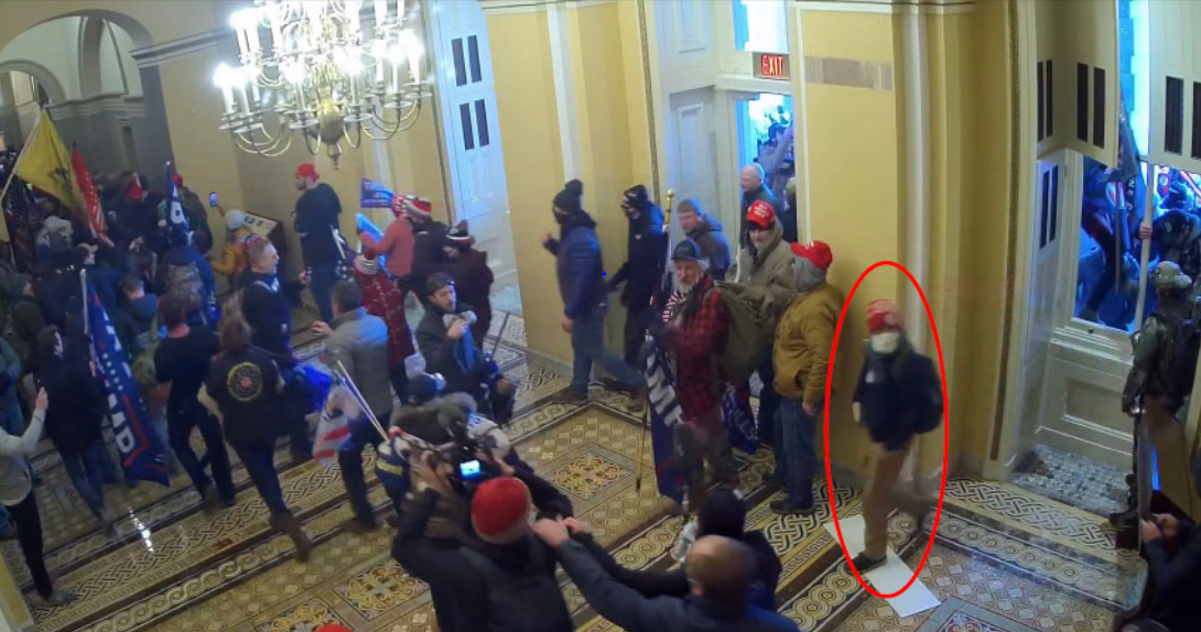 A red circle identifies the man the FBI believes is Paul Caloia in the US Capitol on 6 January 2021.