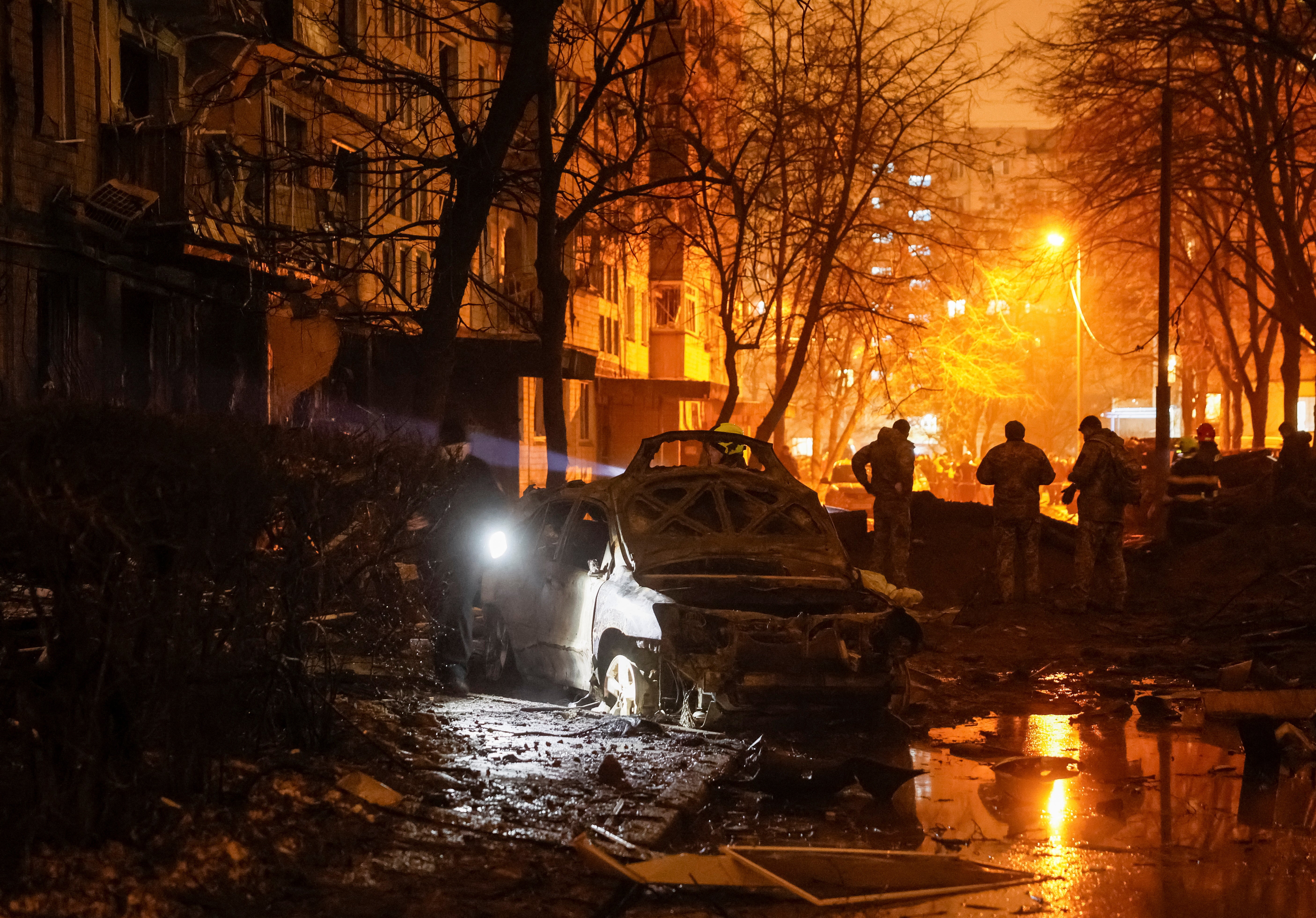 <p>Emergency staff work at a site of an apartment building damaged during a Russian missile strike, amid Russia’s attack on Ukraine</p>