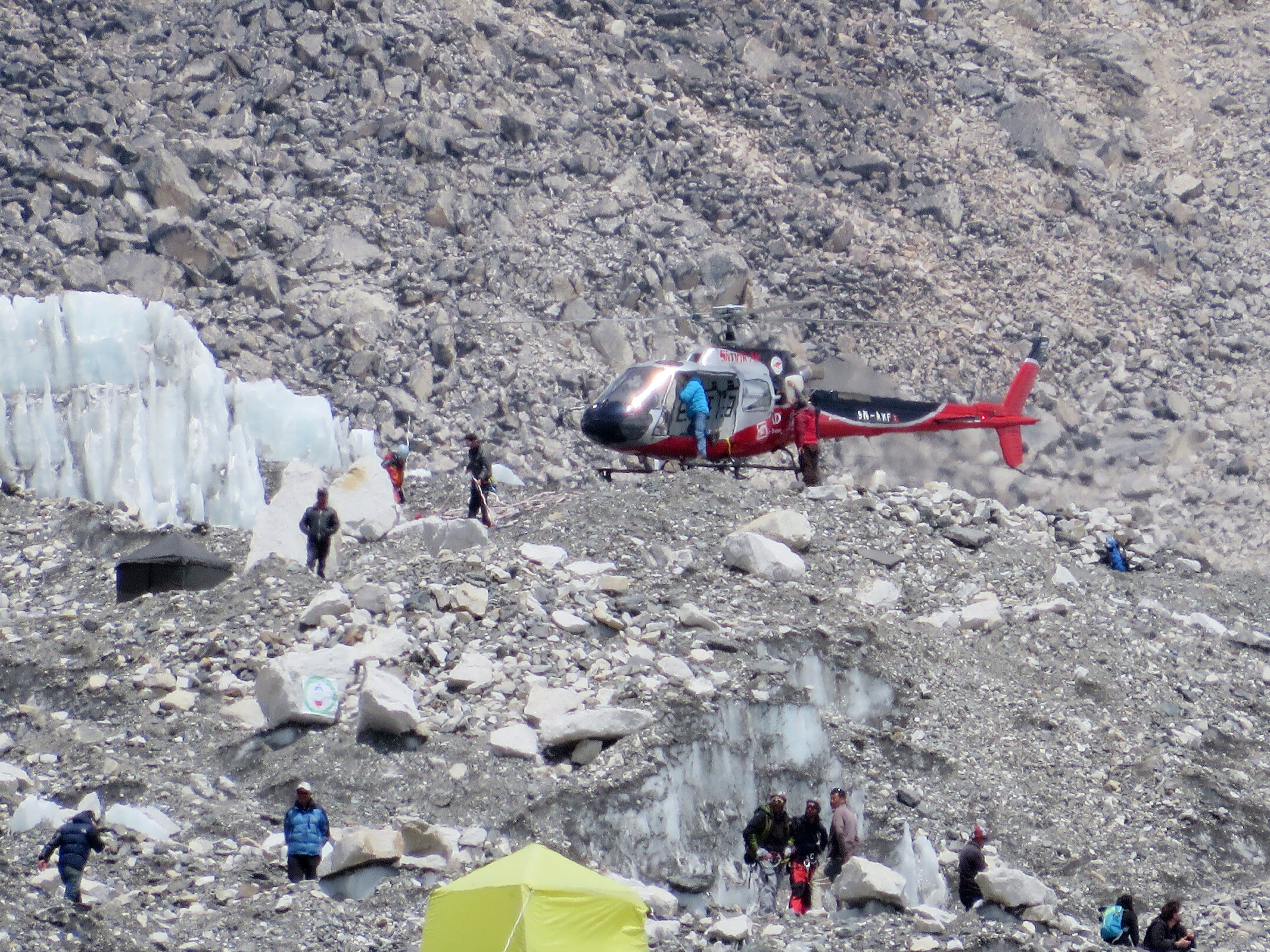 A Nepalese rescue helicopter lands at Everest Base Camp during rescue efforts following an avalanche that killed 16 Nepalese sherpas in the Khumbu icefall in 2014
