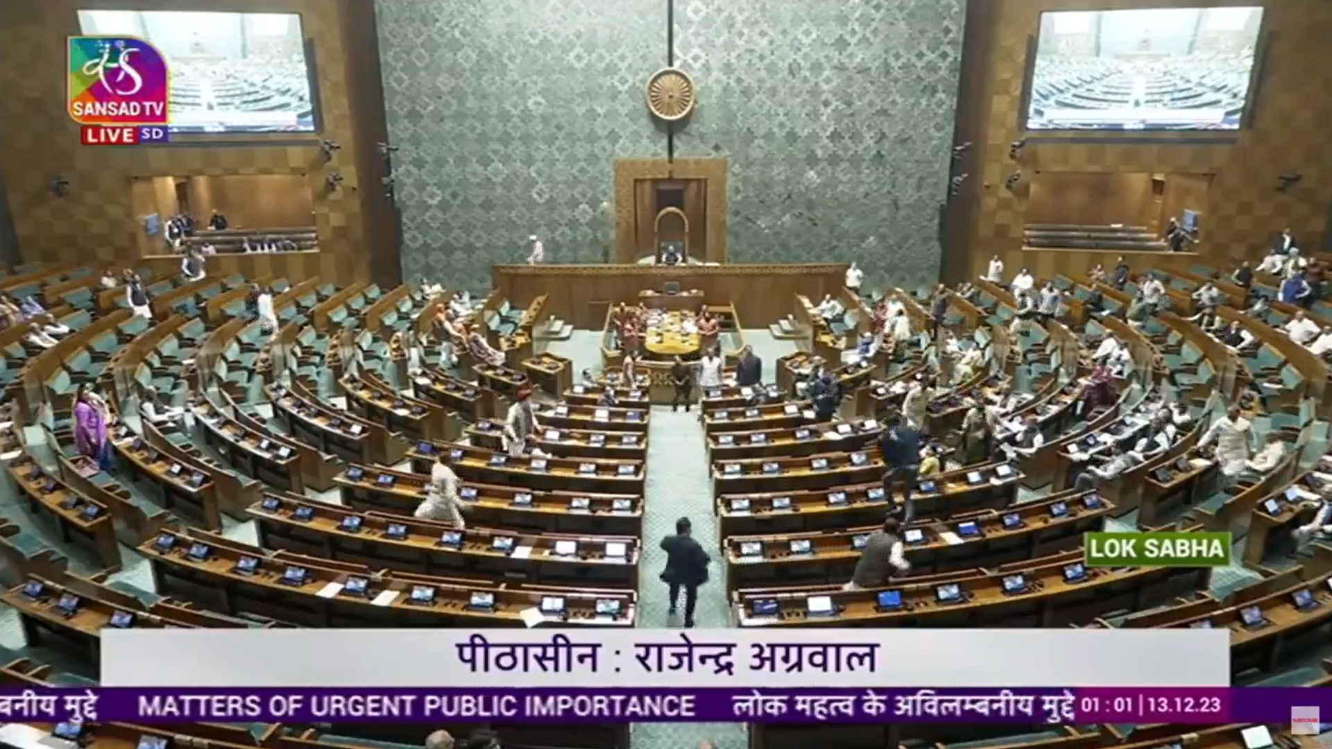 Moment two unidentified men jumped from table to table in lower house of Indian parliament on Wednesday