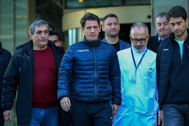 Turkish referee Halil Umut Meler, second left, leaves the Acibadem hospital in Ankara (Ali Unal/AP)