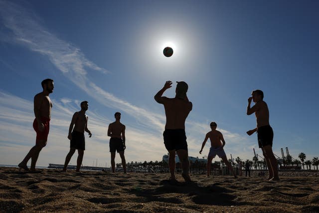 <p>Tourists played on Malagueta beach during an unusually warm winter day on Tuesday</p>