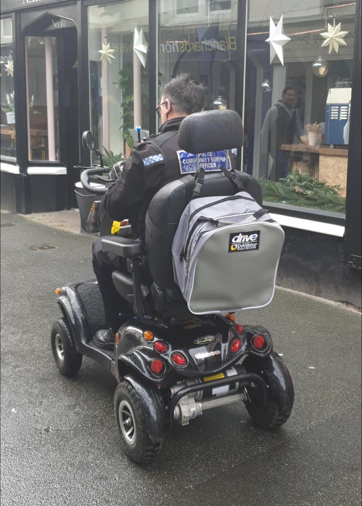 A PCSO drives the scooter back to Bideford police station
