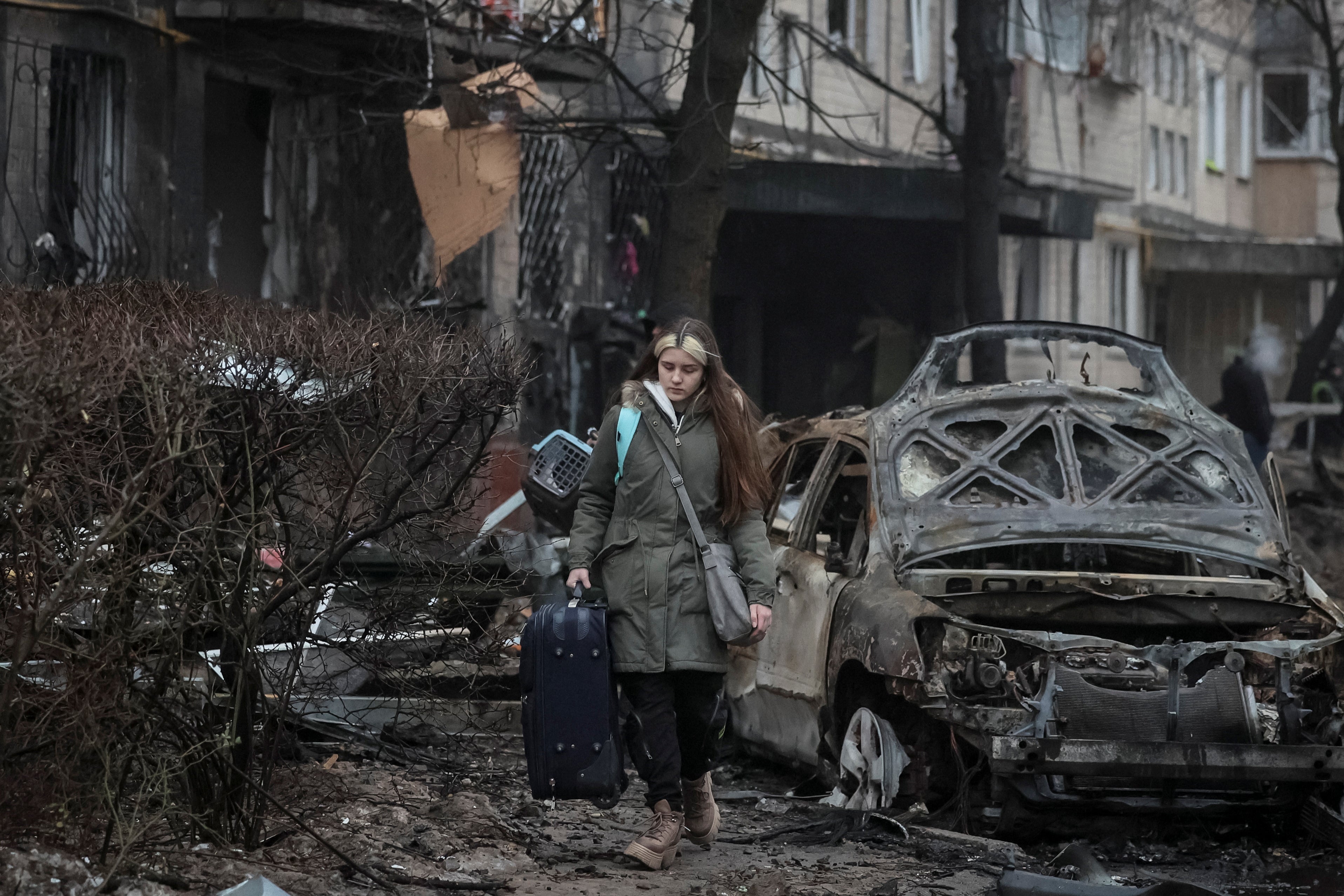 Residents leave their apartment building damaged during a Russian missile strike in Kyiv