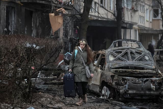 <p>Residents leave their apartment building damaged during a Russian missile strike in Kyiv</p>
