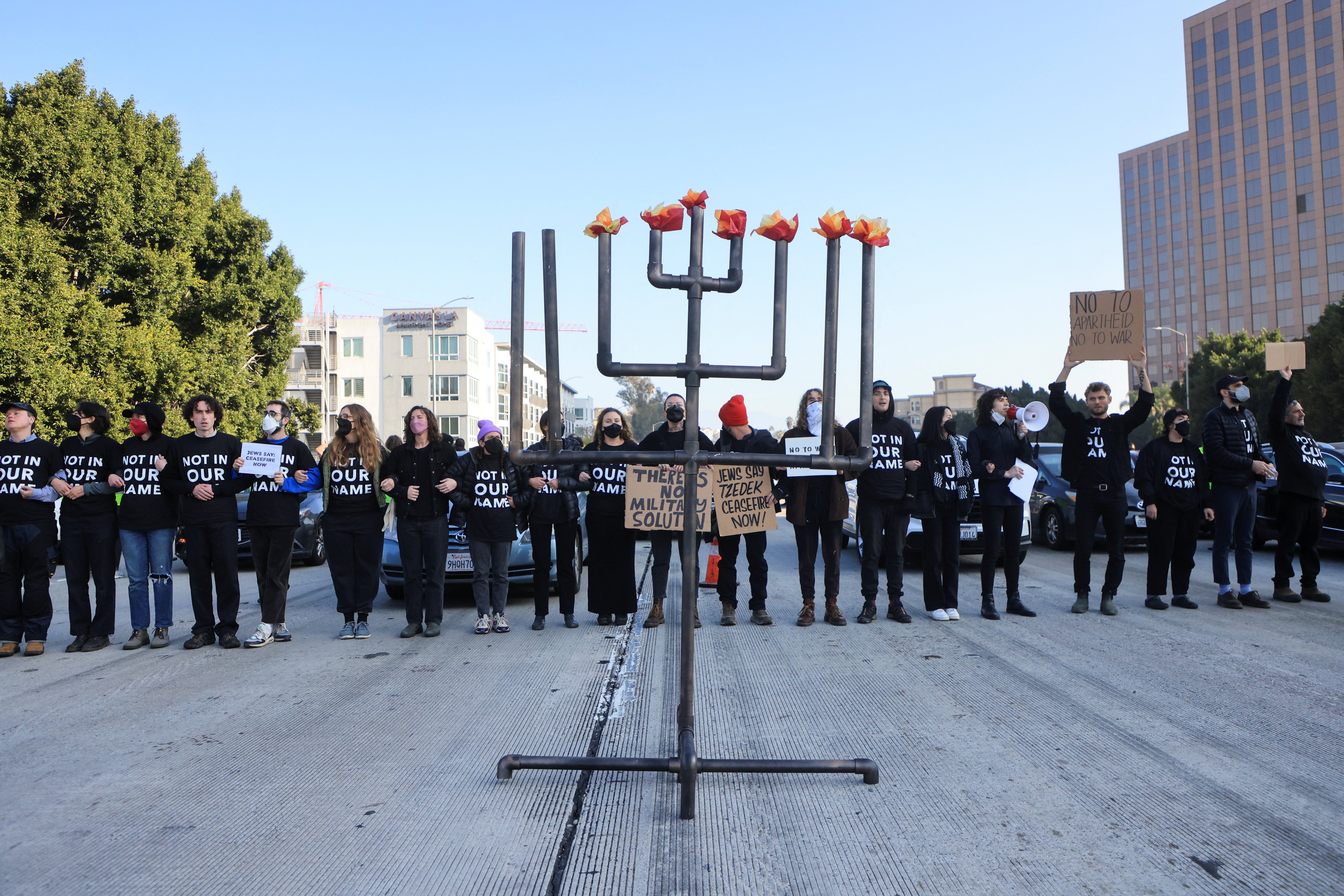 Protesters on the 110 Freeway with a Hanukkiyah, a candlestick with nine branches that is lit to mark Hanukkah, in Los Angeles, California