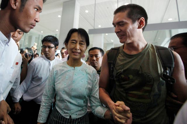 <p>File: Aung San Suu Kyi (C) holds hands with her son Kim Aris after he arrived at Yangon's airport November 23, 2010 </p>