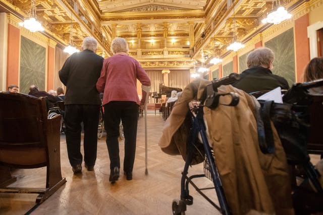 <p>Elderly spectators needing a walking aid arrive to attend a concert specifically tailored to people living with dementia at the Wiener Musikverein in Vienna on December 5, 2022</p>