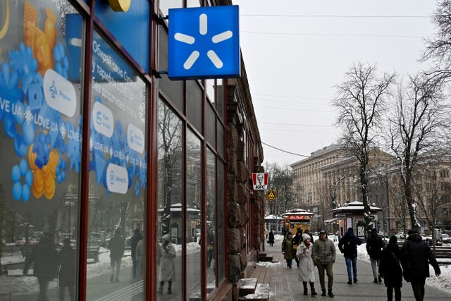 <p>People walk by a Kyivstar store, a Ukrainian telecommunications company, in Kyiv</p>