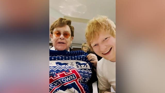 <p>Ed Sheeran and Elton John swap Christmas presents and pull crackers as they watch Ipswich Town match.</p>