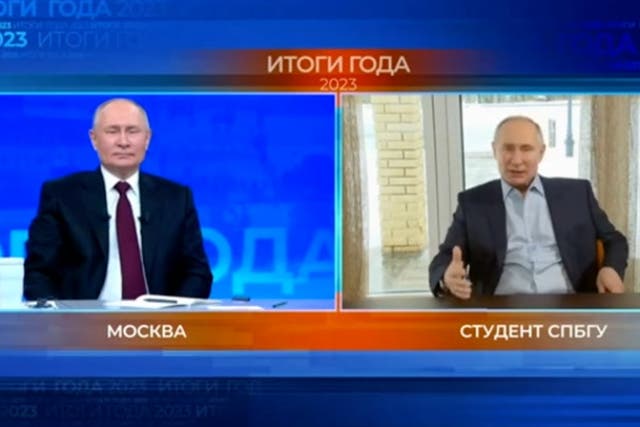 <p>Double cross: Putin takes a question from an AI-generated lookalike, billed as a ‘resident of St Petersburg’</p>