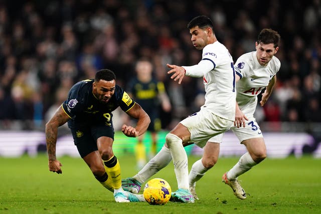 Newcastle’s Callum Wilson is tackled by Tottenham centre-back Cristian Romero (John Walton/PA)