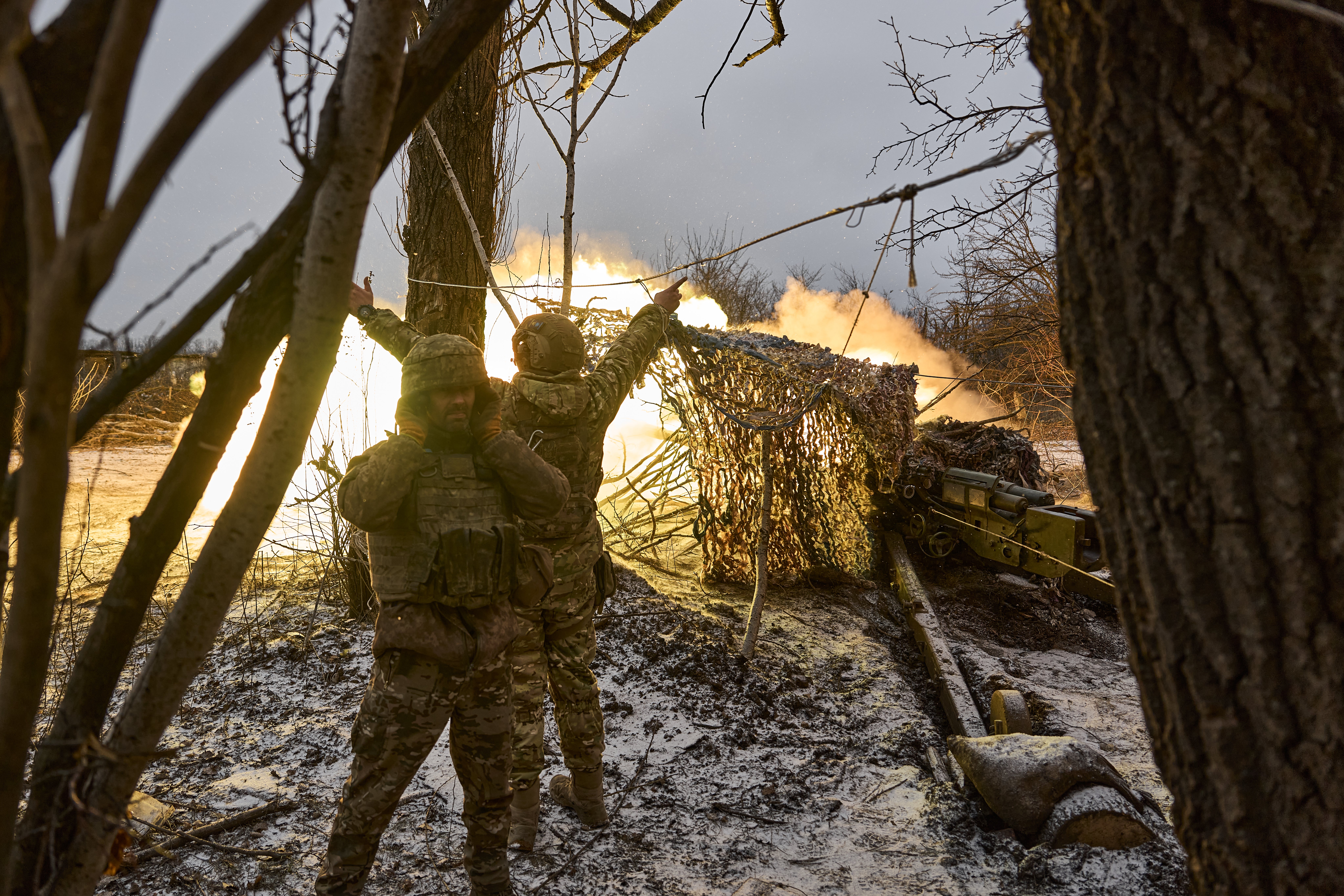 Ukrainian soldiers fire from an anti-tank gun in Avdiivka
