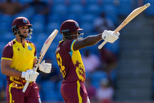 West Indies’ Rovman Powell celebrated scoring a half-century with Brandon King (Ricardo Mazalan/AP)