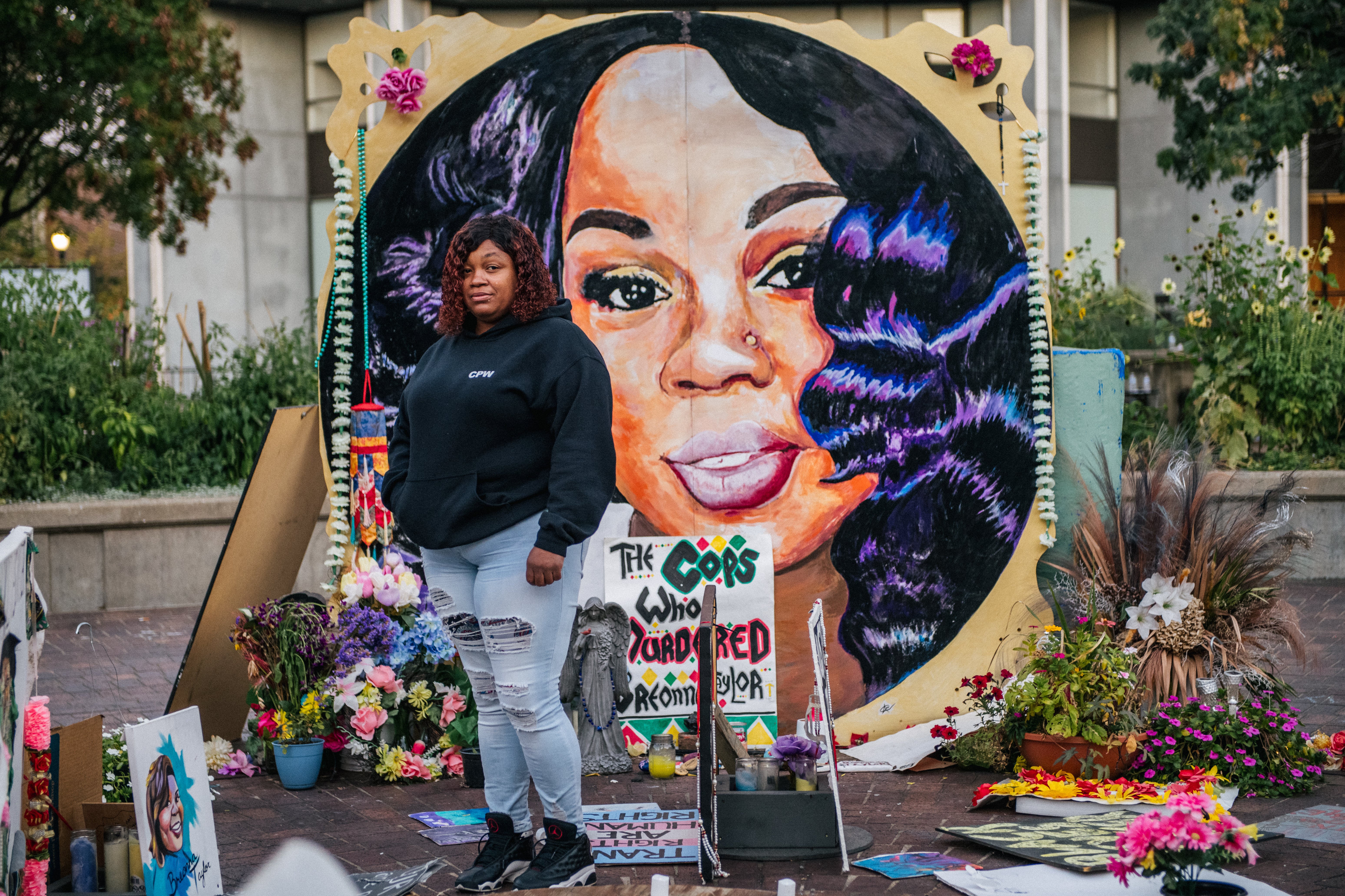 Tamika Palmer, mother of Breonna Taylor, poses for a portrait in front of a mural of her daughter at Jefferson Square park in 2020