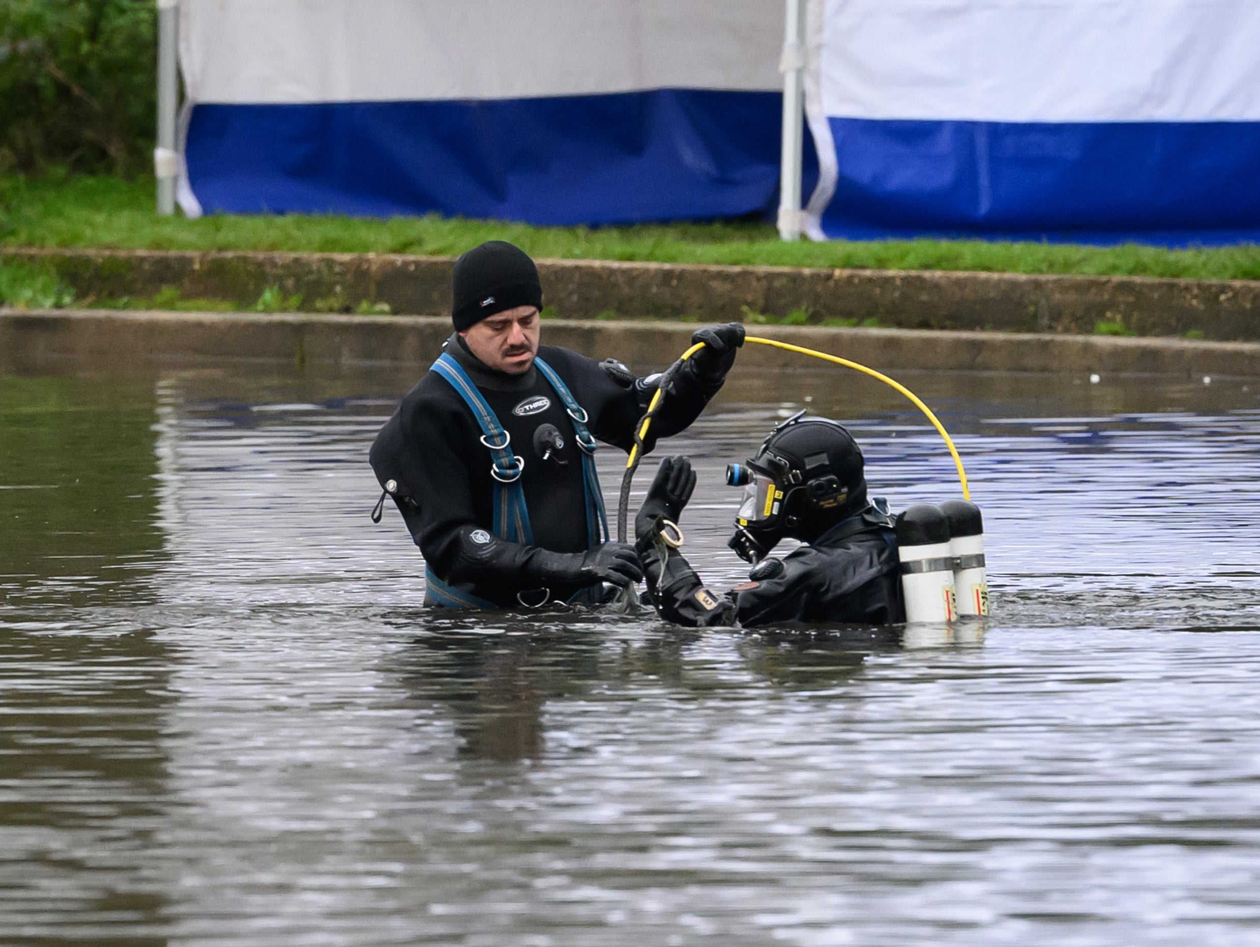 Police search teams in the River Wensum