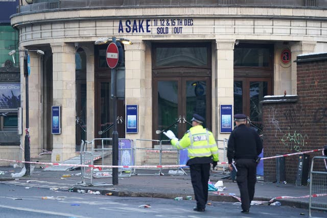 <p>Police officers outside Brixton O2 Academy, where two people died 12 months ago (Kirsty O’Connor/PA)</p>