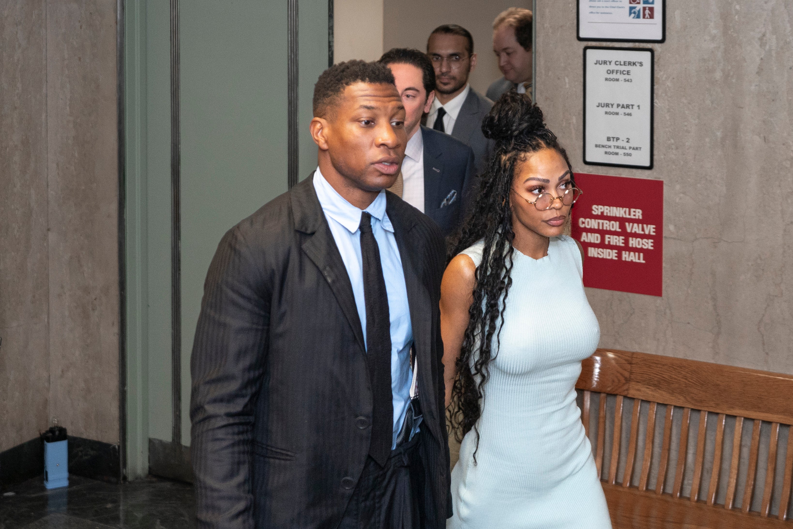 Jonathan Majors, accompanied by girlfriend Meagan Good, enters a courtroom at the Manhattan Criminal Courthouse in New York on 14 December