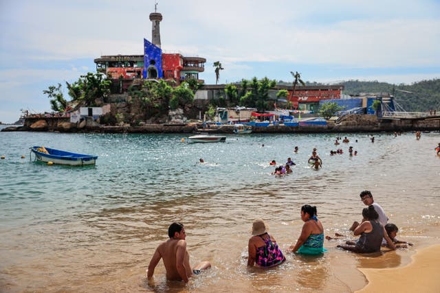 <p>FILE: Tourists enjoy a beach in the resort of Acapulco, Guerrero state, Mexico</p>