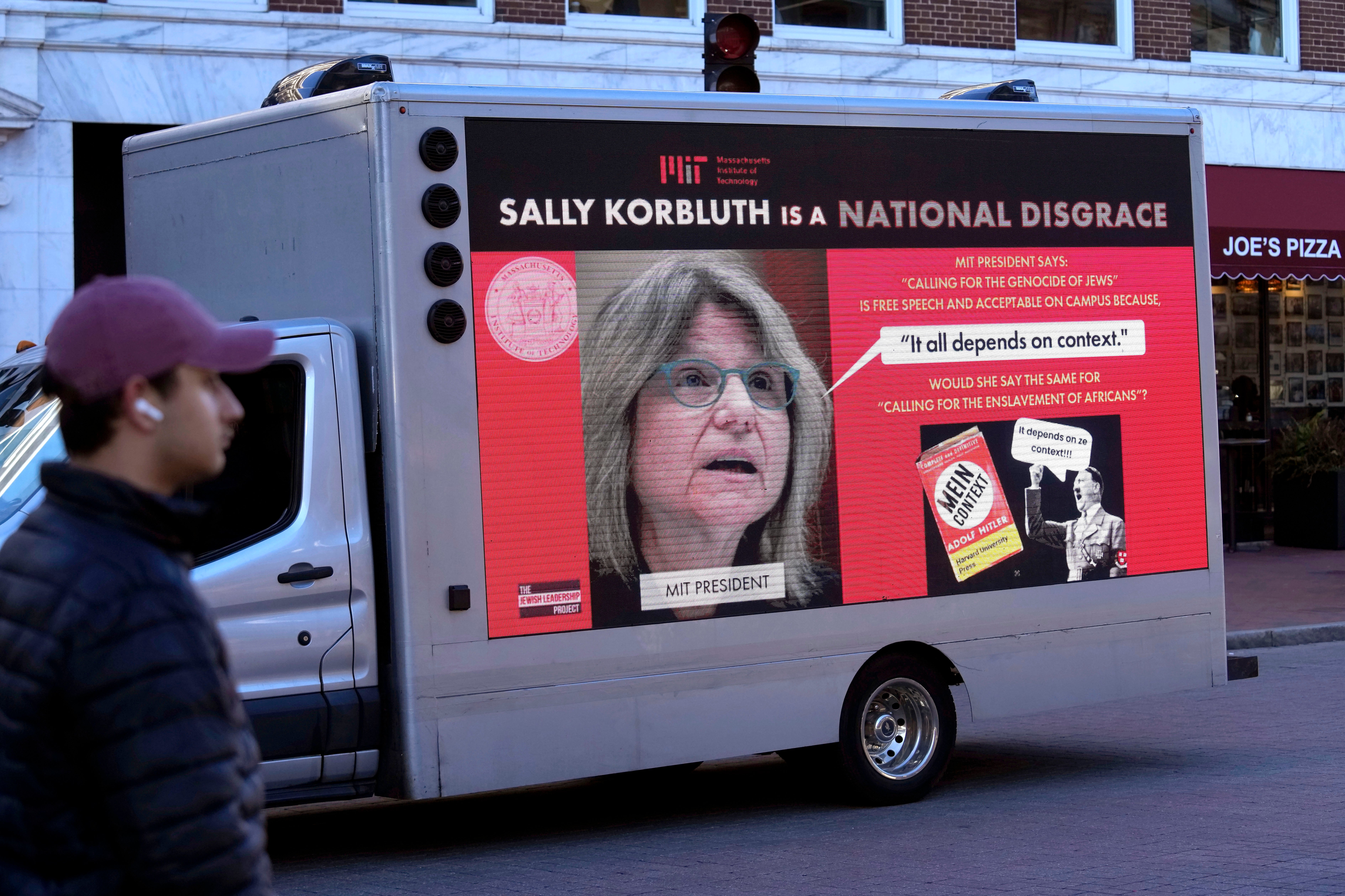 A truck with electronic panels drives along a street on 12 December near Harvard University, in Cambridge, Mass, while displaying messages calling attention to a recent controversy involving testimony to Congress by presidents of three prestigious schools, including Harvard University, MIT, and the University of Pennsylvania