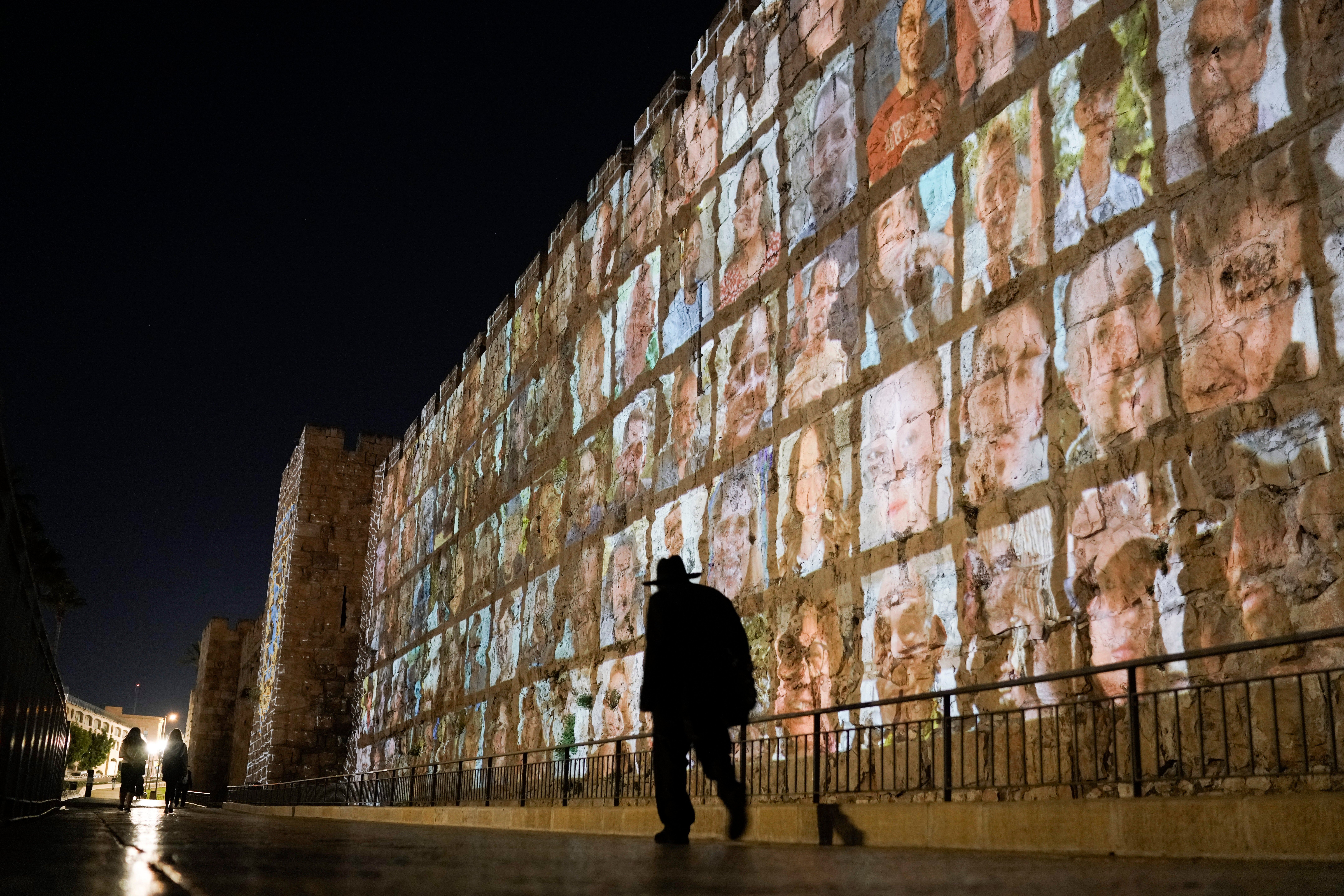 Photographs of Israeli hostages being held by Hamas militants are projected on the walls of Jerusalem's Old City in November