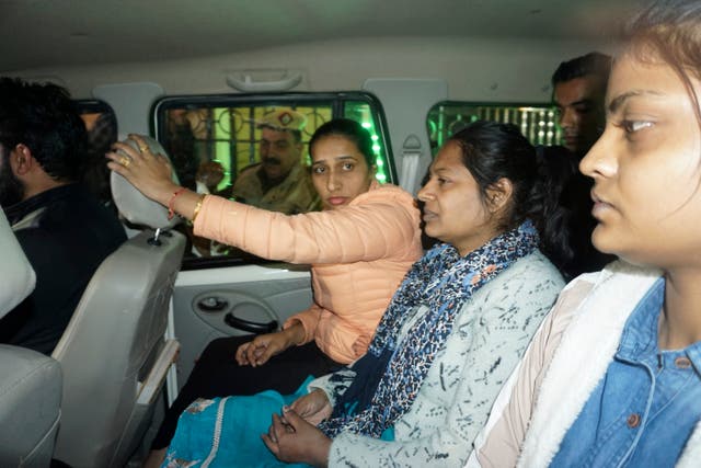 <p>Neelam Azad, center, an accomplice in Wednesday's security breach in the Indian parliament, is escorted to be taken into police custody, in New Delhi, India,</p>