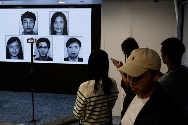 <p>Images of five activists Simon Cheng, Frances Hui, Joey Siu, Johnny Fok, and Tony Choi are displayed during a press conference to issue arrest warrants in Hong Kong</p>