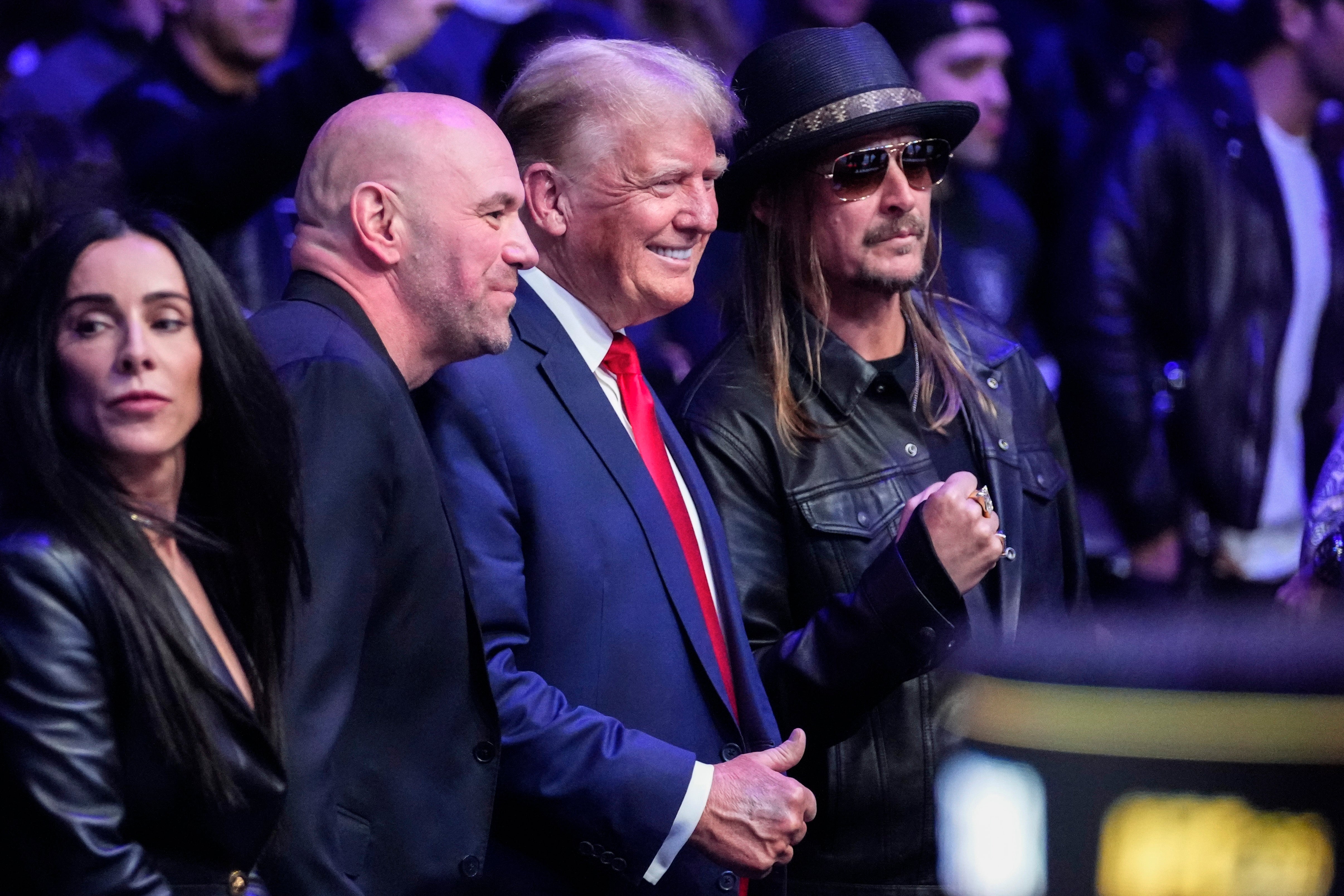Donald Trump poses for pictures with Dana White (L) and Kid Rock (R)