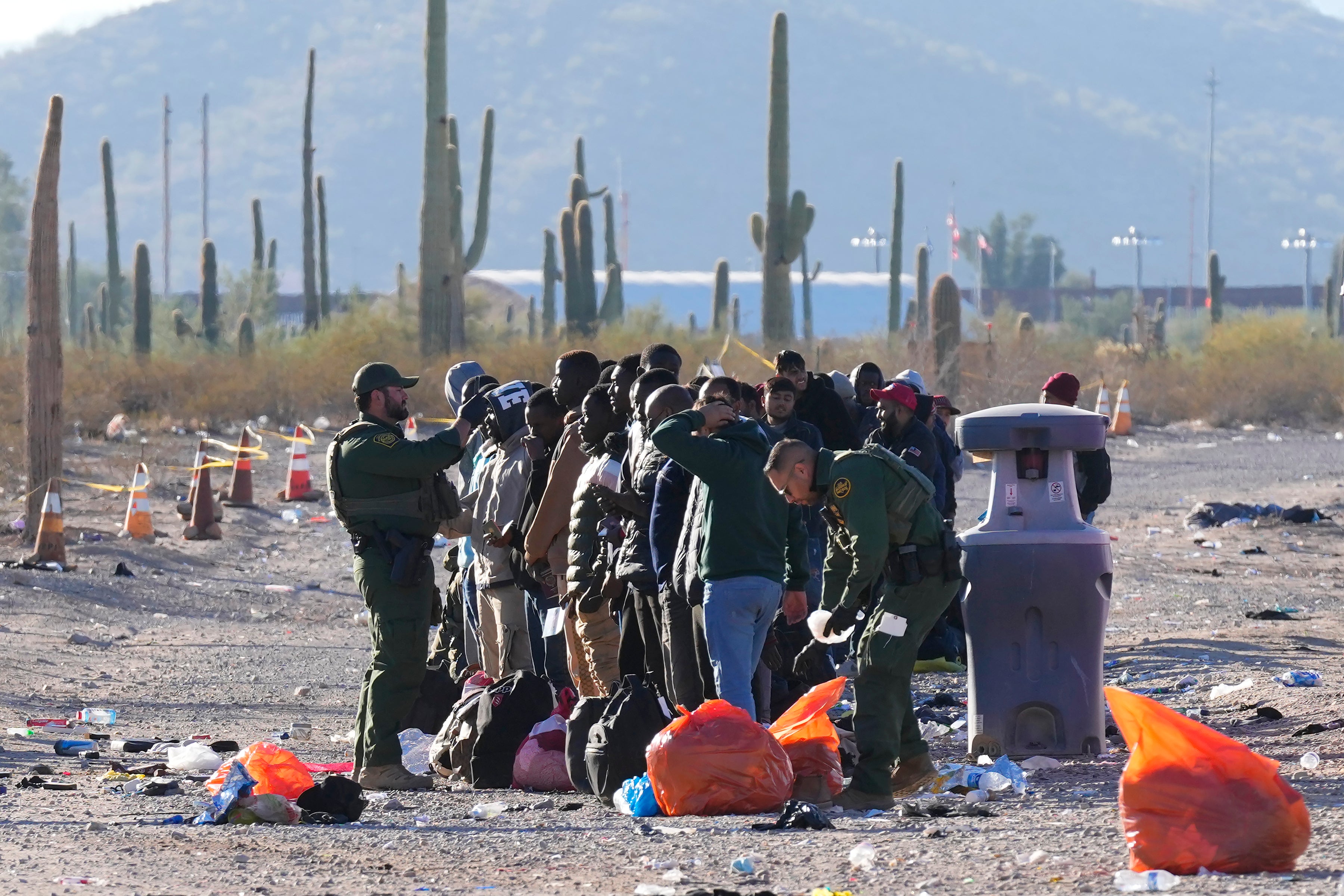 US Border Patrol officers with a group of migrants near the southern border