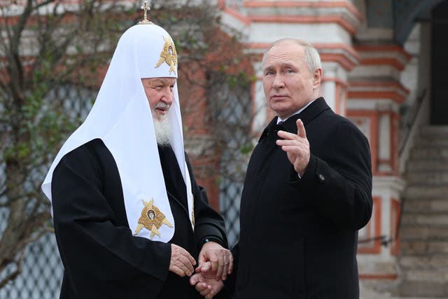 <p>Vladimir Putin and Russian Orthodox Patriarch Kirill (L) talking during a wreath-laying ceremony at the Monument to Minin and Pozharsky on Red Square on the National Unity Day in Moscow</p>