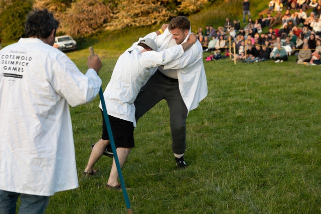 <p>Mike grapples with an opponent </p>