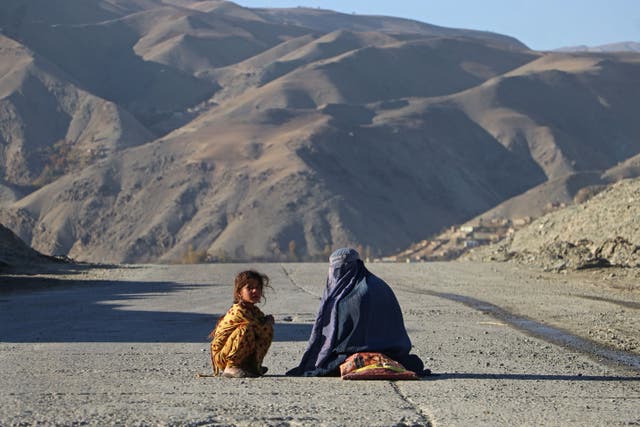 <p>A woman sits beside a girl, as they beg for alms in Badakhshan region of  northern Afghanistan </p>