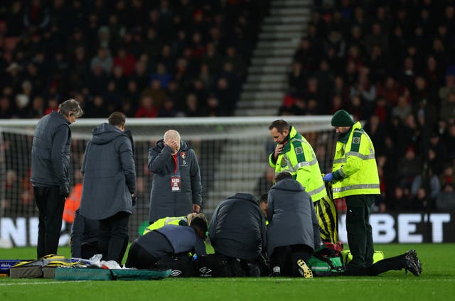 <p>Medics surrounded Luton Town player Tom Lockyer after he collapses </p>