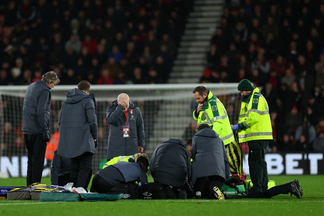 <p>Medics surrounded Luton Town player Tom Lockyer after he collapses </p>
